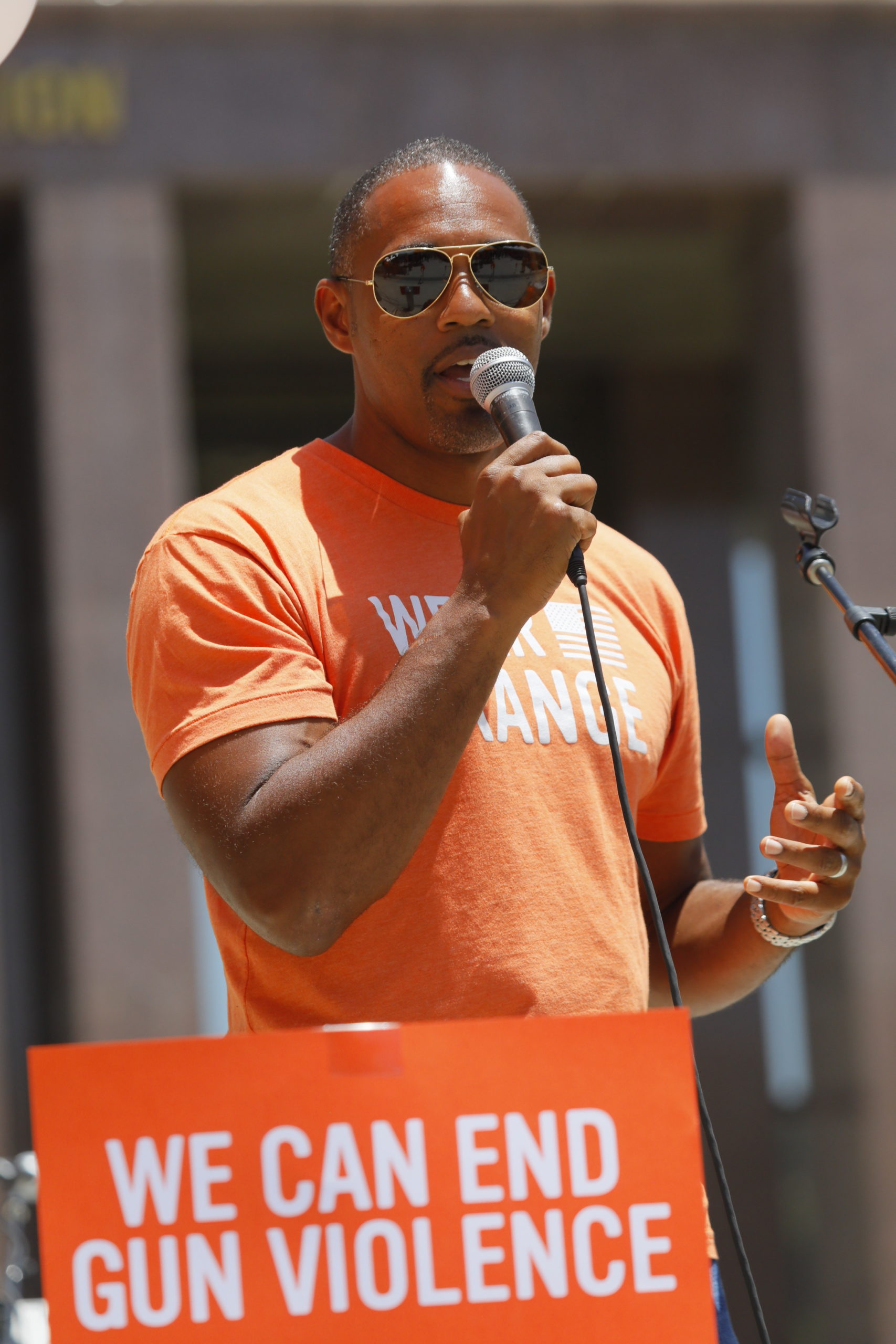 Jason Winston George speaks at a Wear Orange event