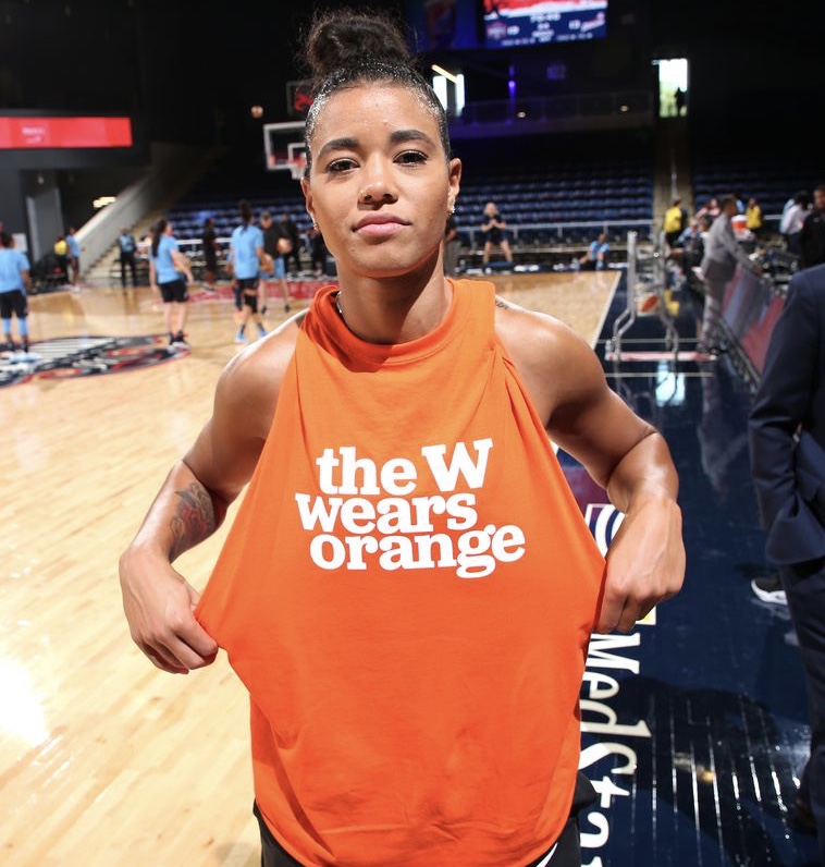 WMBA player Natasha Cloud shows off her Wear Orange shirt on the basketball court
