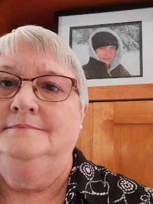 Dorothy takes a selfie in front of her son and father