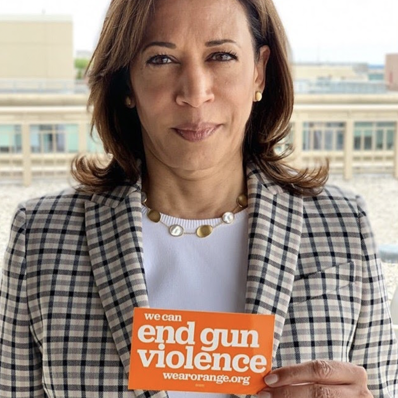 Vice President Kamala Harris holds up a 'We can end gun violence' sticker