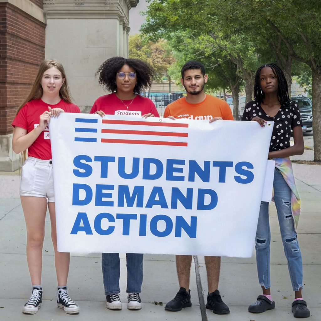 Chicago Summer Leadership Academy participants hold up a Students Demand Action banner