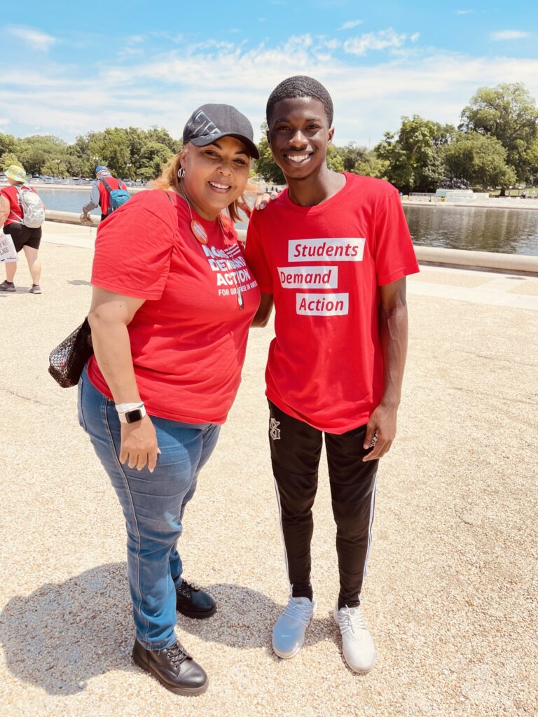Jakoby Mitchell poses for a photo with a Moms Demand Action volunteer