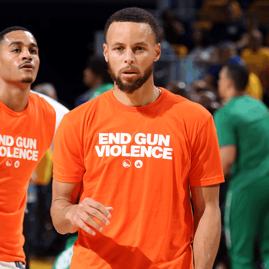 Stephen Curry wearing an orange End Gun Violence t-shirt
