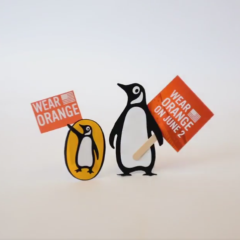 Penguin Books logo carrying Wear Orange signs