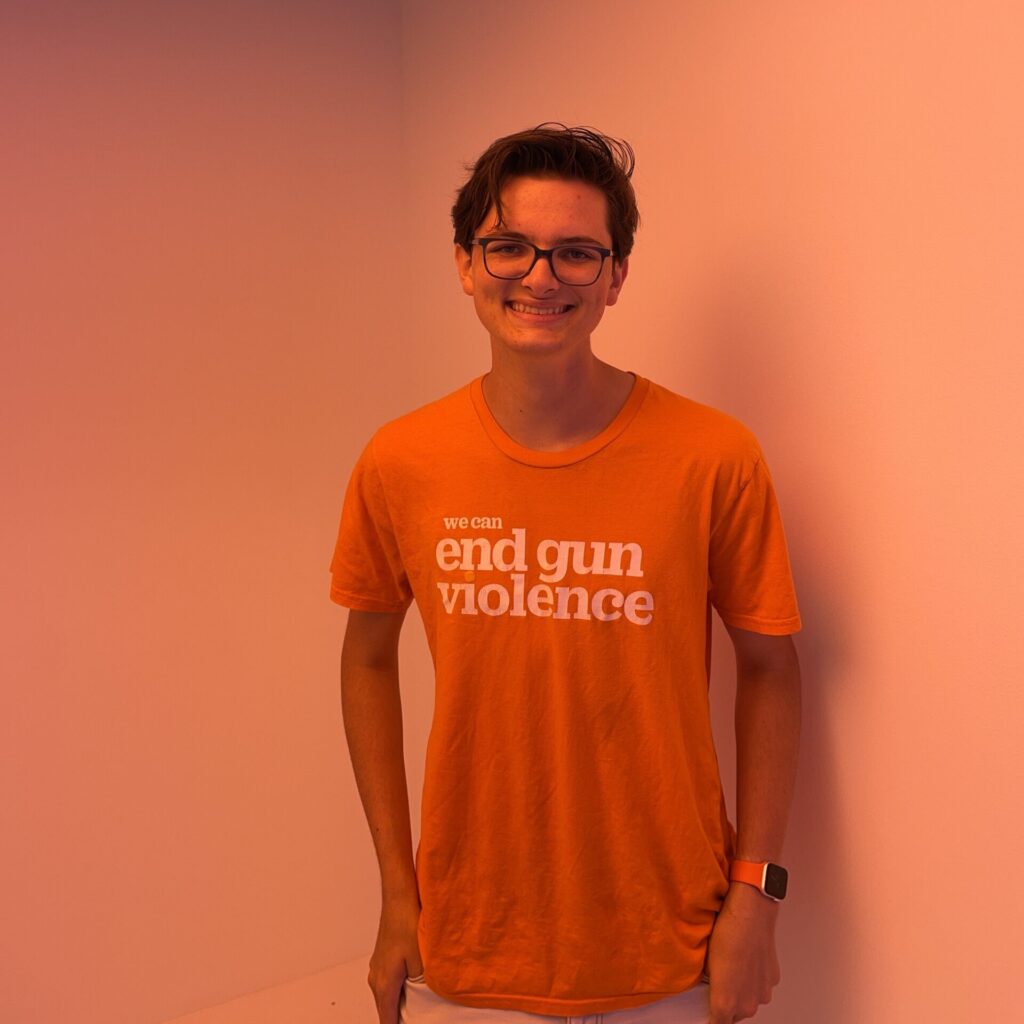 Roan Thibault wearing an orange "we can end gun violence" t-shirt