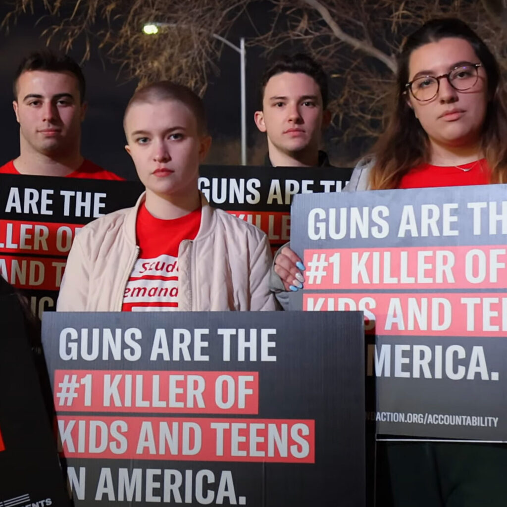 Students Demand Action volunteers holding signs that say “Guns are the #1 killer of kids and teens in America."
