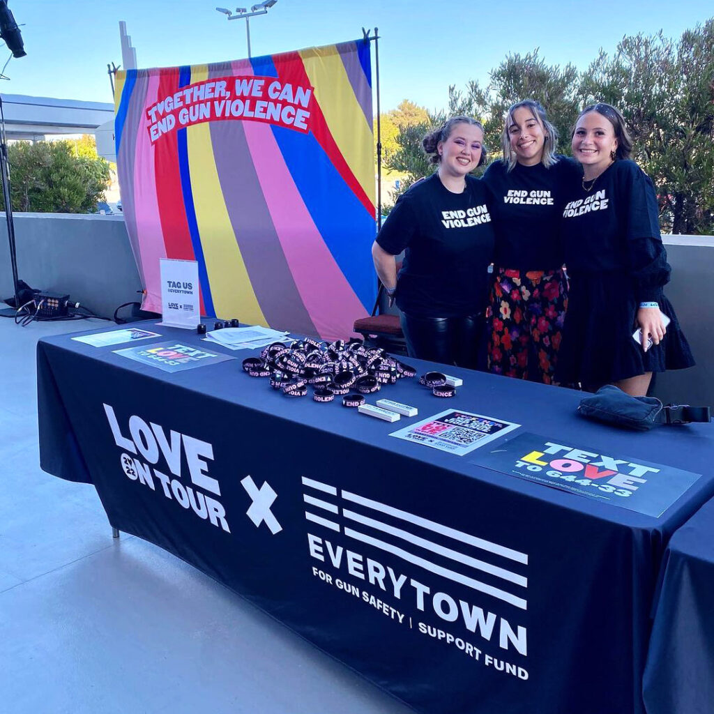 Everytown staff members pose for a photo tabling at Harry Styles x Love on Tour