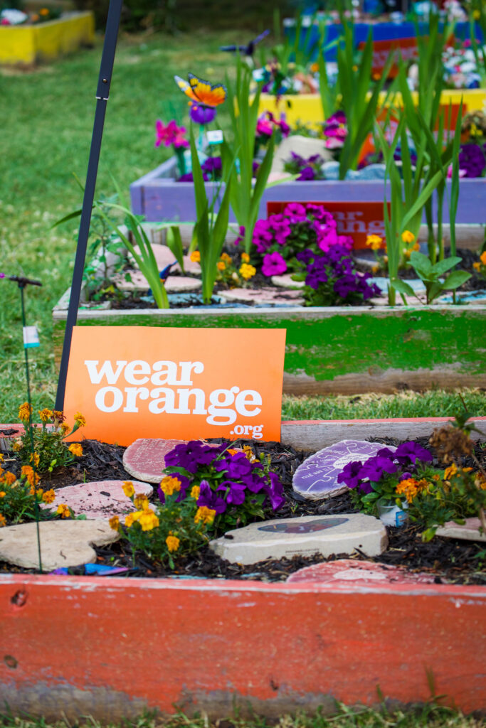 A Wear Orange sign on the community garden in Baltimore
