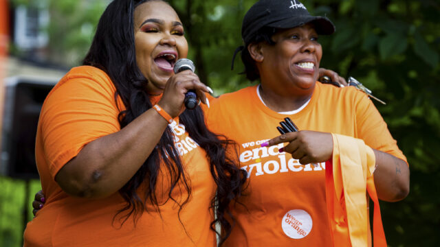 Two people wearing Wear Orange t-shirts