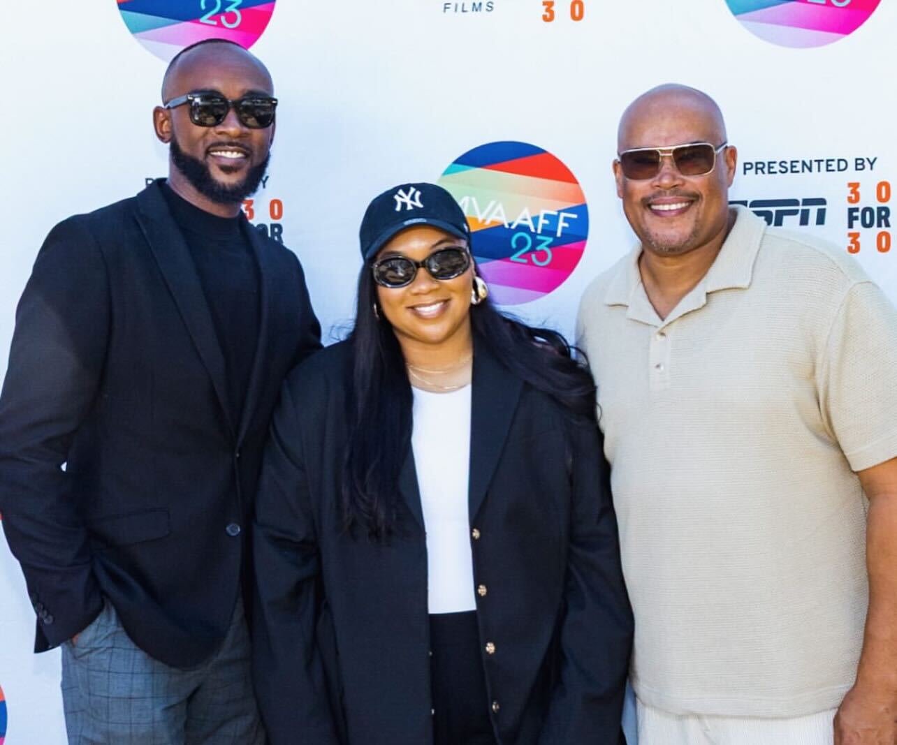 Michael-Sean Spence, Santana Coleman, and Marcus McAllister pose for a photo at the Martha's Vineyard African American Film Festival screening of the Pieces of the Puzzle documentary. All three wear professional clothing and sunglasses.